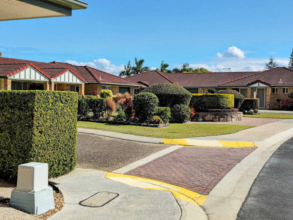 Clipped hedges and maintained paths between retirement village homes